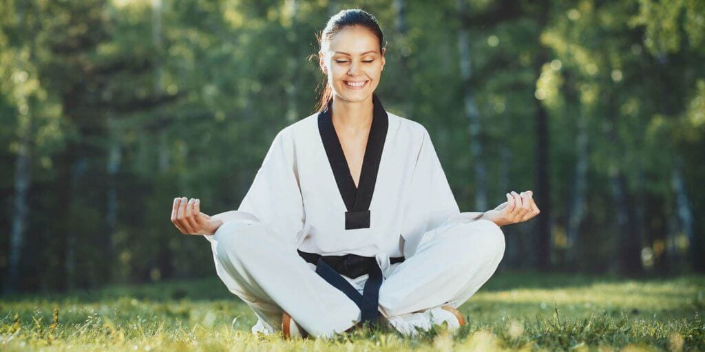 Martial Arts Lessons for Adults in Louisville  KY - Happy Woman Meditated Sitting Background